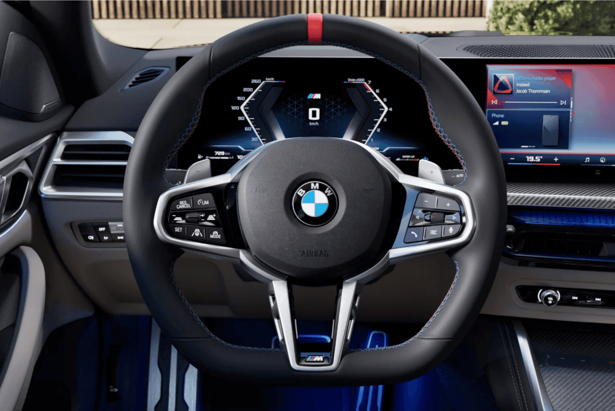 BMW steering wheel with digital display, M logo, and red stripe.