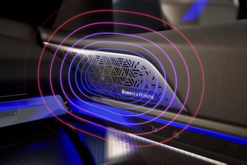 Bowers & Wilkins speaker grille with concentric circles emanating from it, illuminated by blue light.