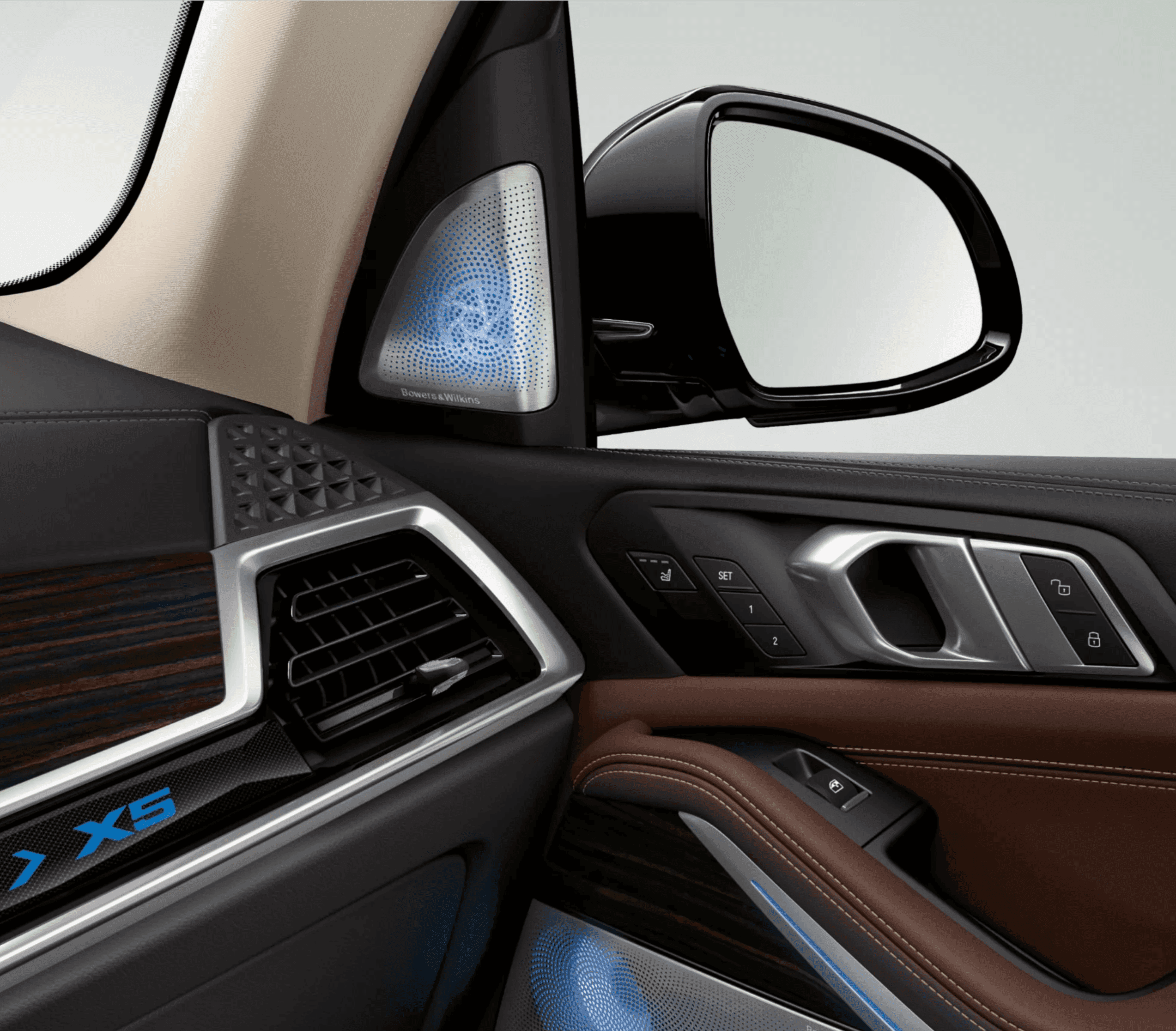 Close-up of a car's interior, featuring a side mirror, door controls, air vent, and ambient lighting.