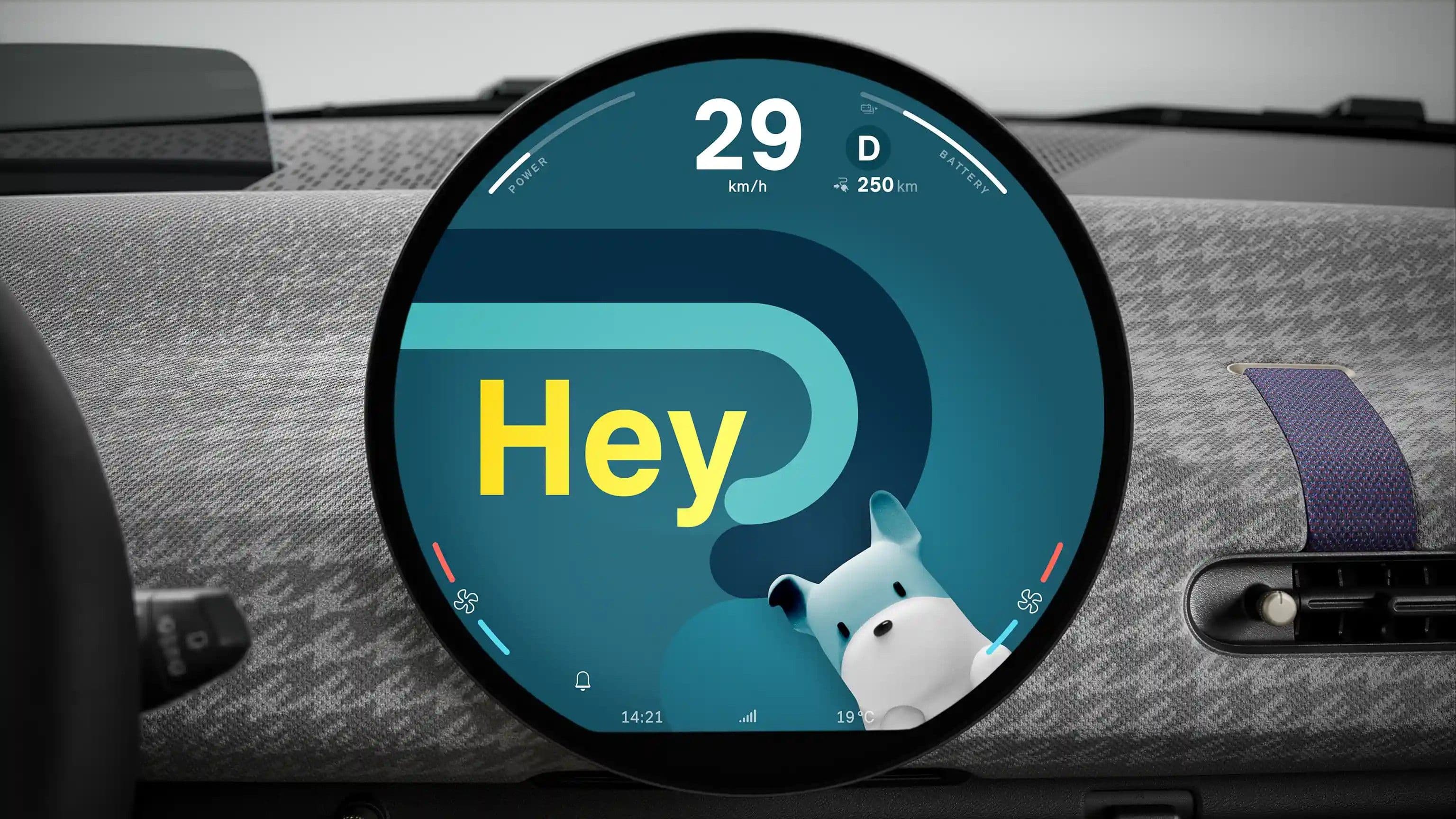 Car dashboard display shows 'Hey' and a cartoon dog on a circular screen.