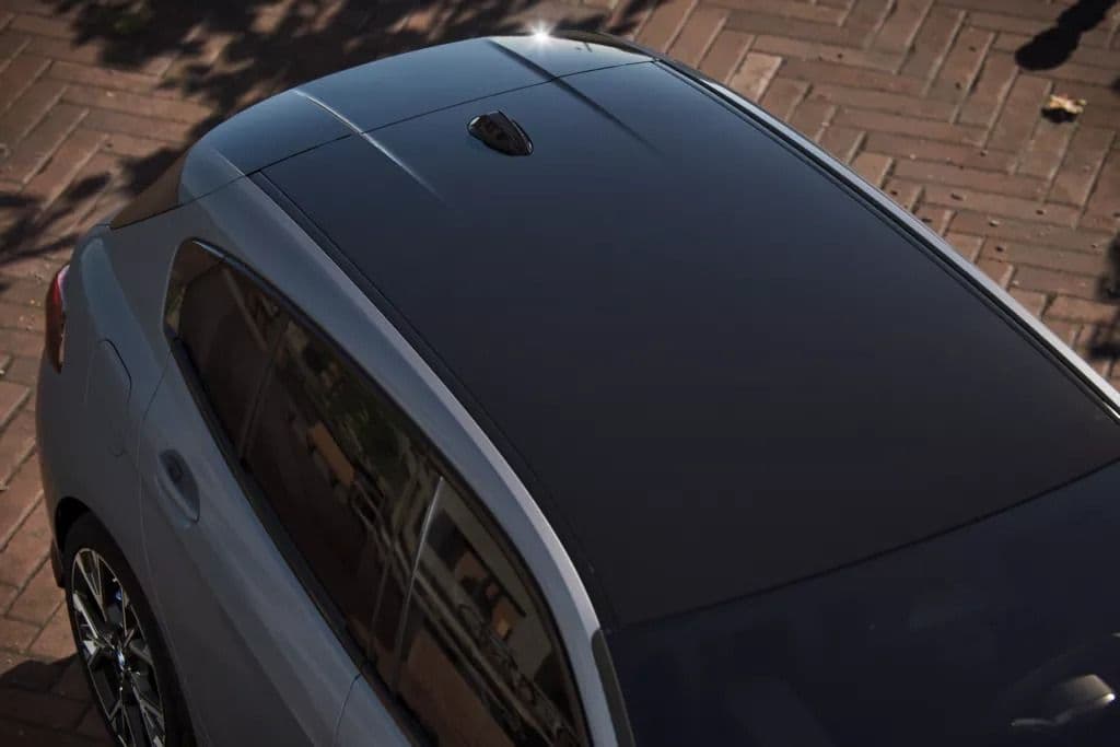Close-up aerial view of a car's black panoramic sunroof.