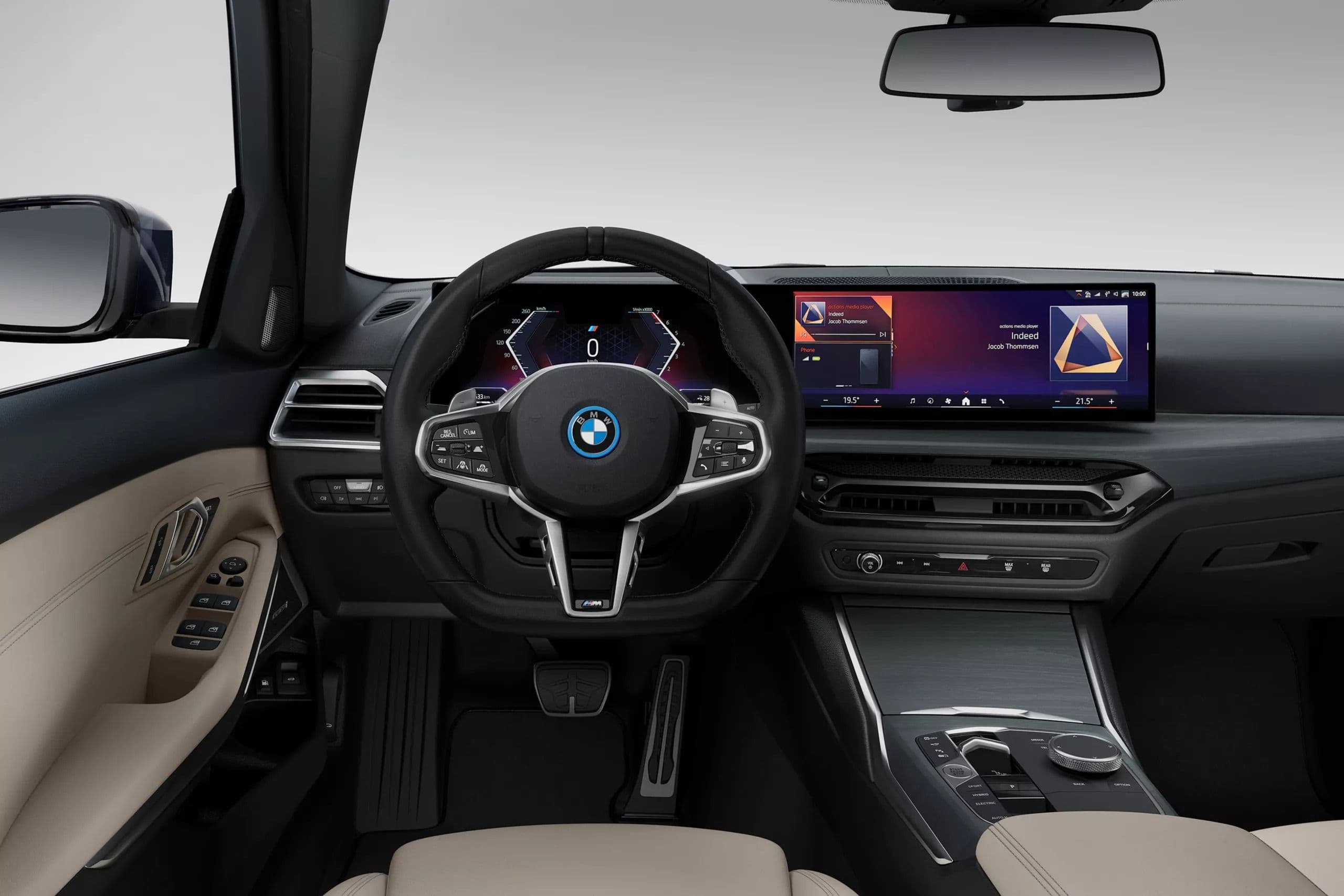 Modern BMW interior featuring a large curved display screen and digital instrument cluster.