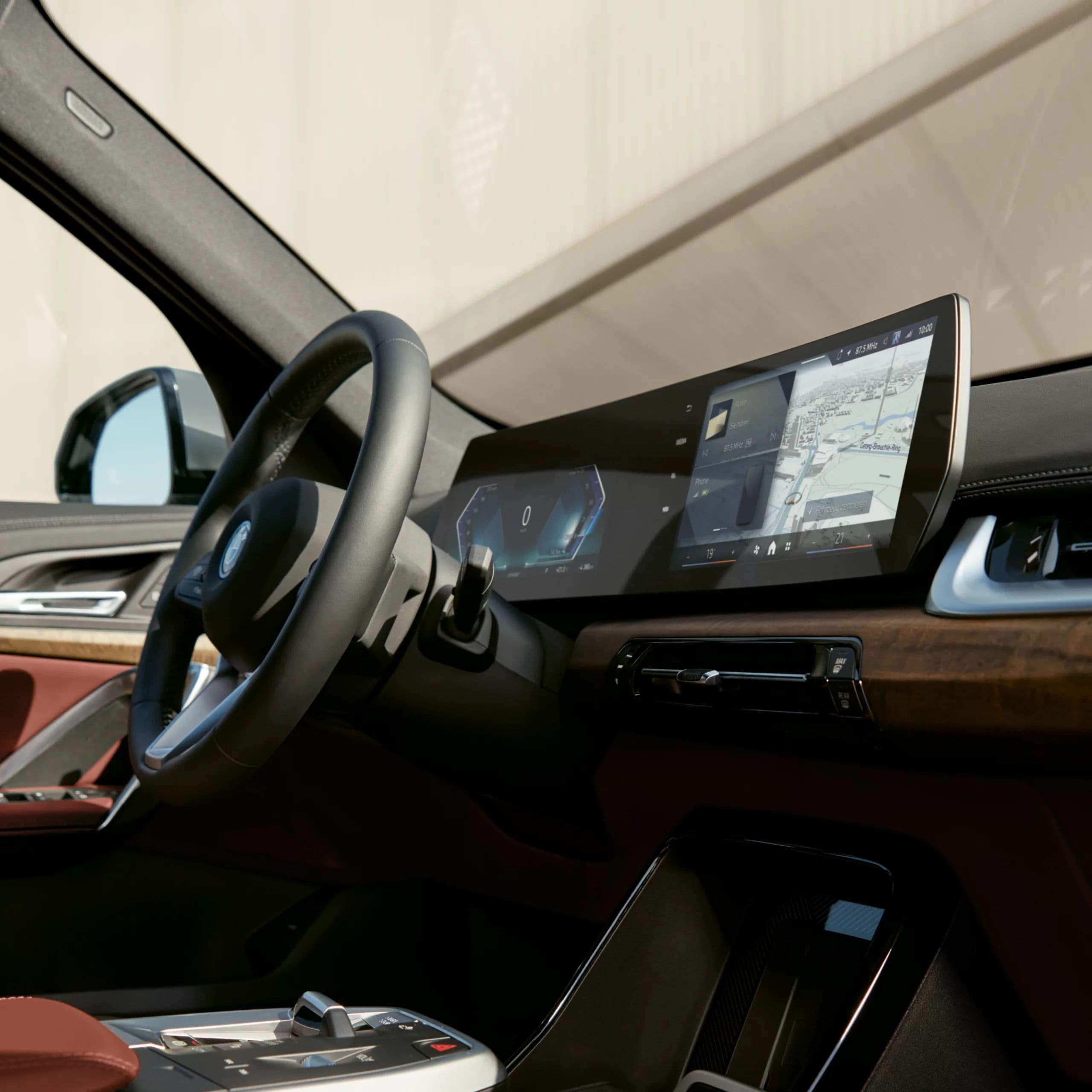 Dashboard of a luxury car with a large infotainment screen and digital instrument cluster.