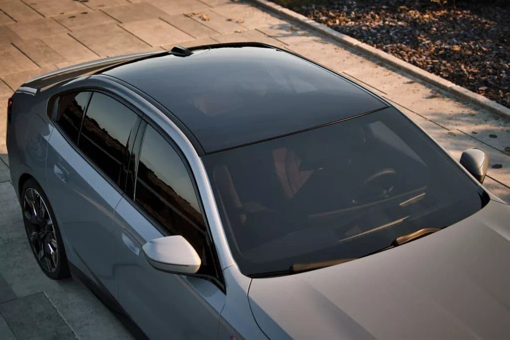 Top view of a silver sedan with a panoramic glass roof.
