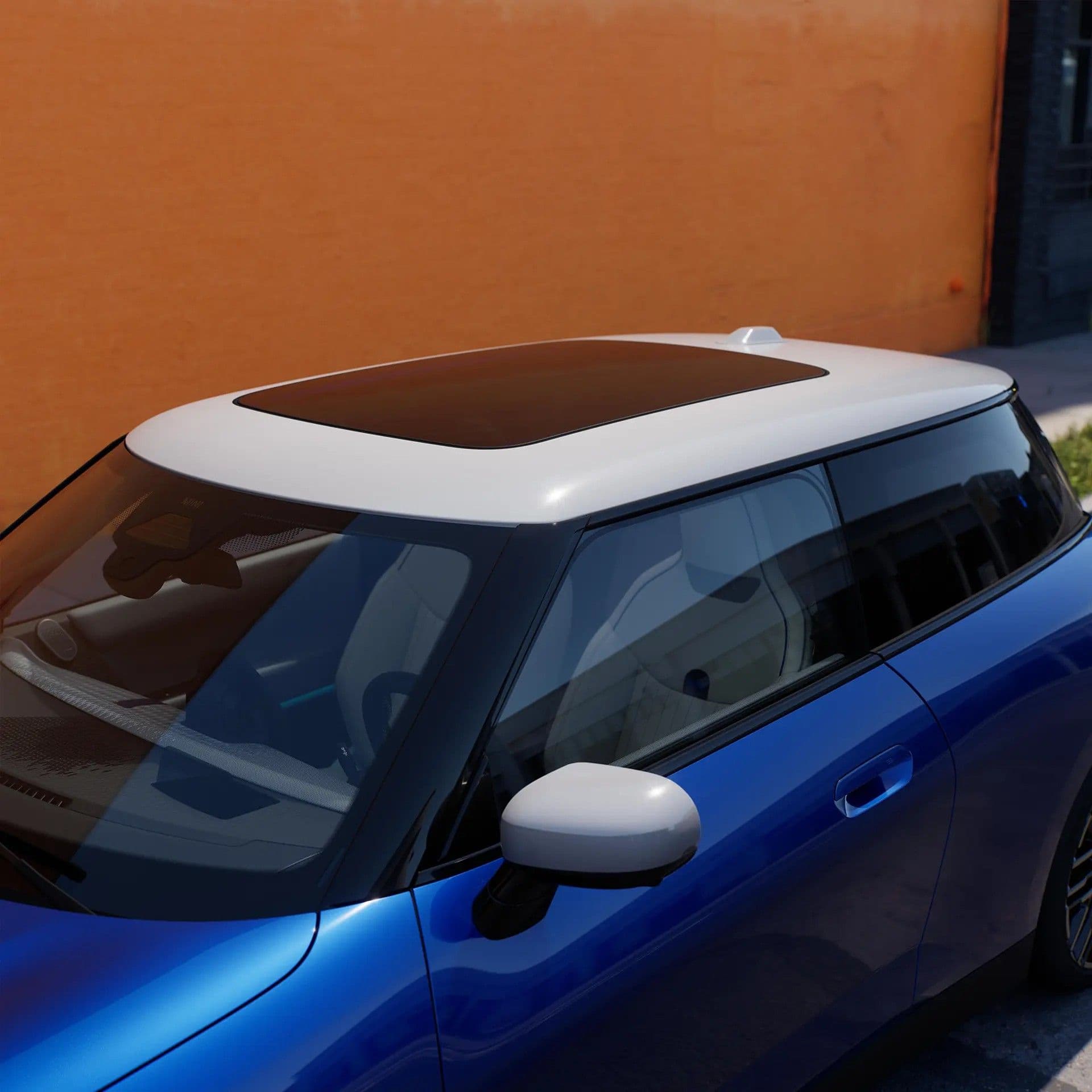 Close-up of a blue Mini Cooper with a white roof and a panoramic sunroof.