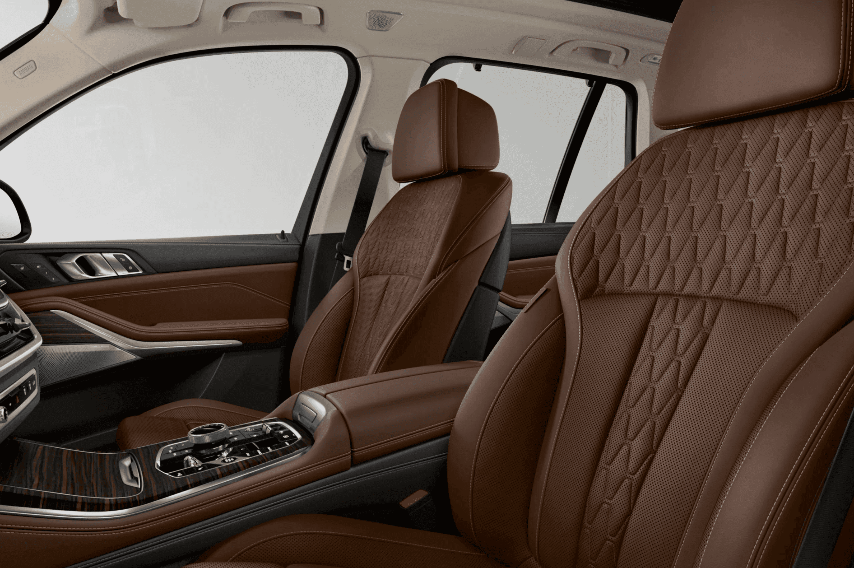 Brown quilted leather seats in the interior of a luxury car.