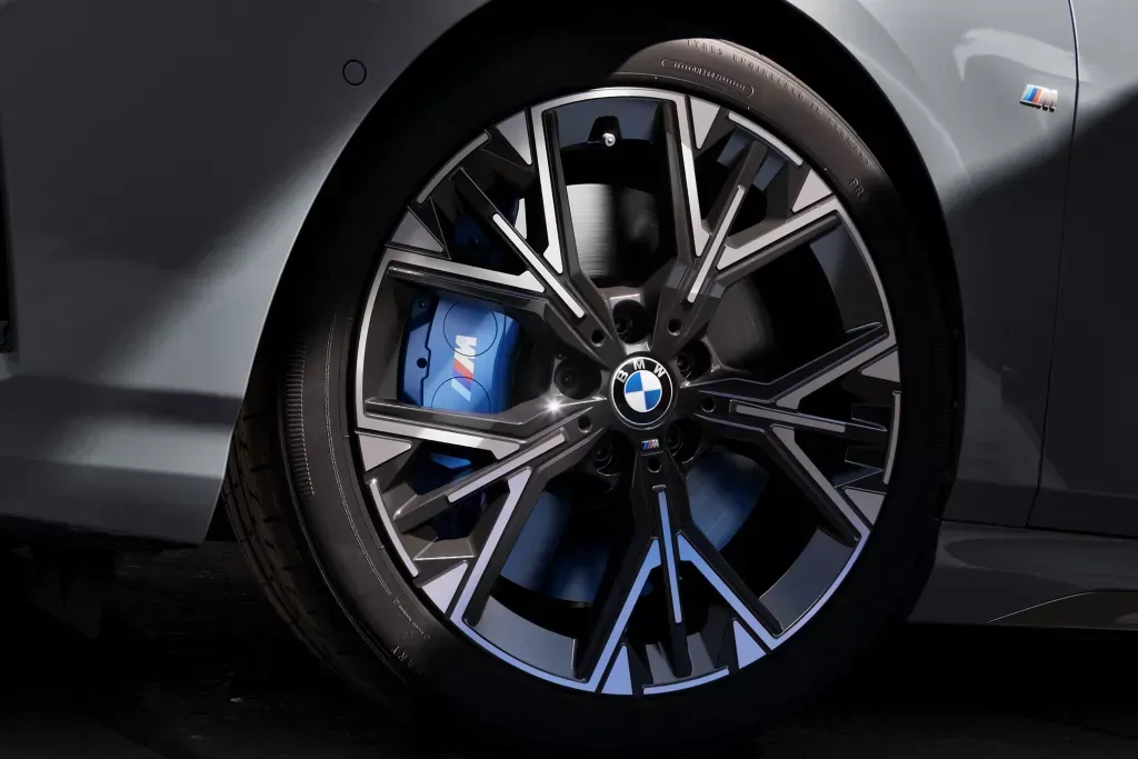 Close-up of a BMW M Sport wheel with blue brake calipers.